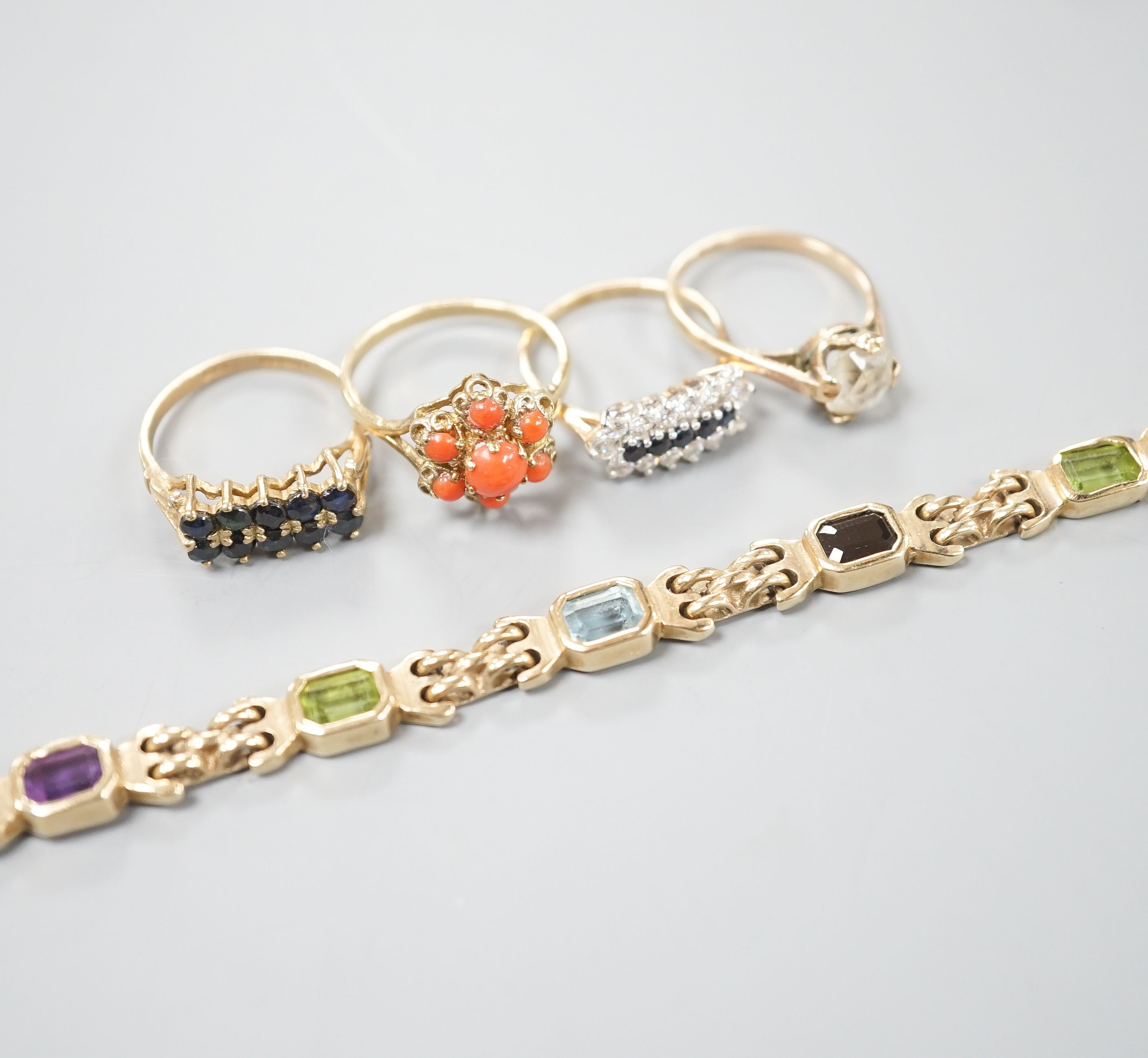 A modern 9ct gold and gem set bracelet and four assorted 9ct gold dress rings, gross 24.8 grams